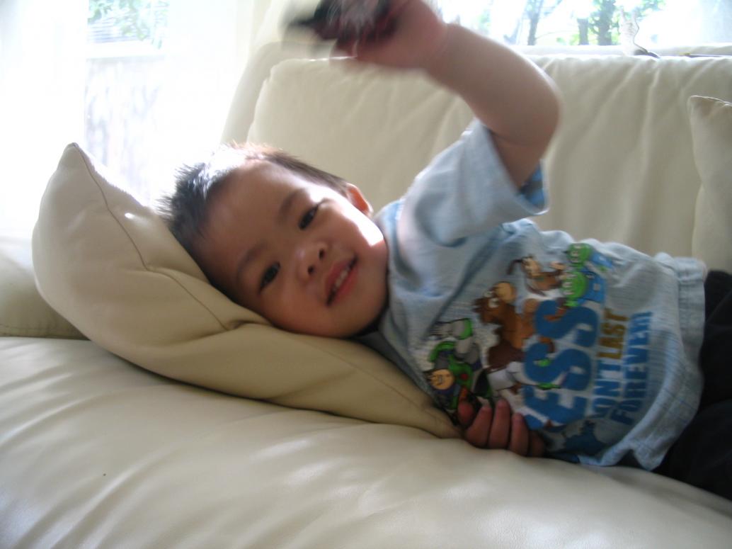 Ngồi mỏi thì nằm lăn ra ghế, tay vẫn còn cầm xe hơi.